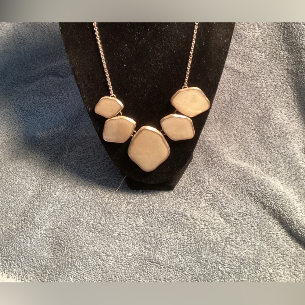Large iridescent ivory colored stone necklace.